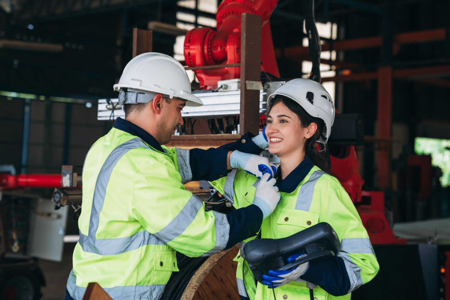 Engineers take care of each other in the workplace. Workers are controlling the automated robot arms machine welding steel welding robots.